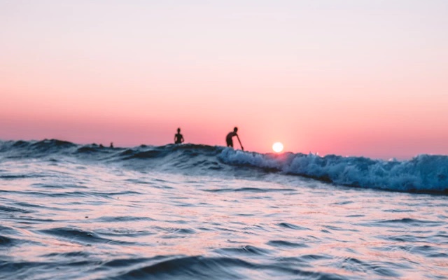 kids playing on the beach with sunset